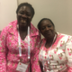 Midwives from the Ivory Coast at the opening ceremony, both wearing dresses made with custom textiles bearing their midwife association’s name. Photo by Kathryn Jezer-Morton.